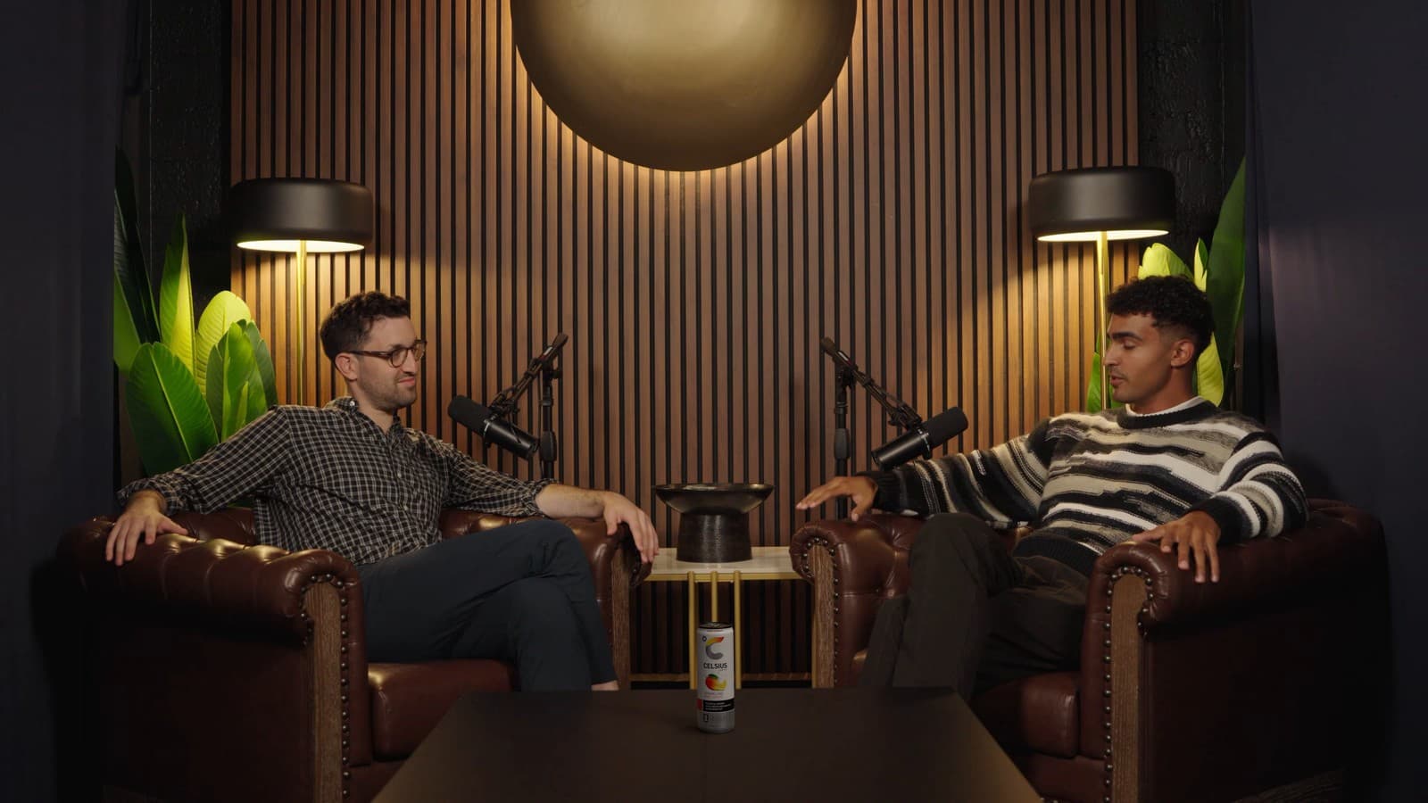 A Celsius can on the table of a podcast set